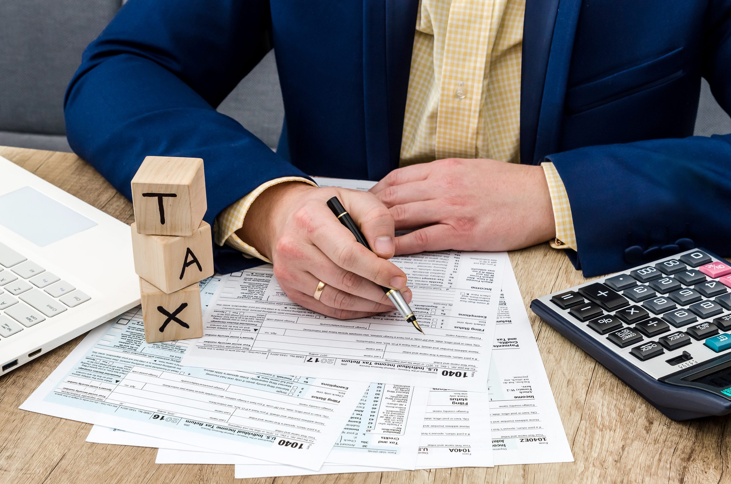 Tax time. Male hands filling 1040 form